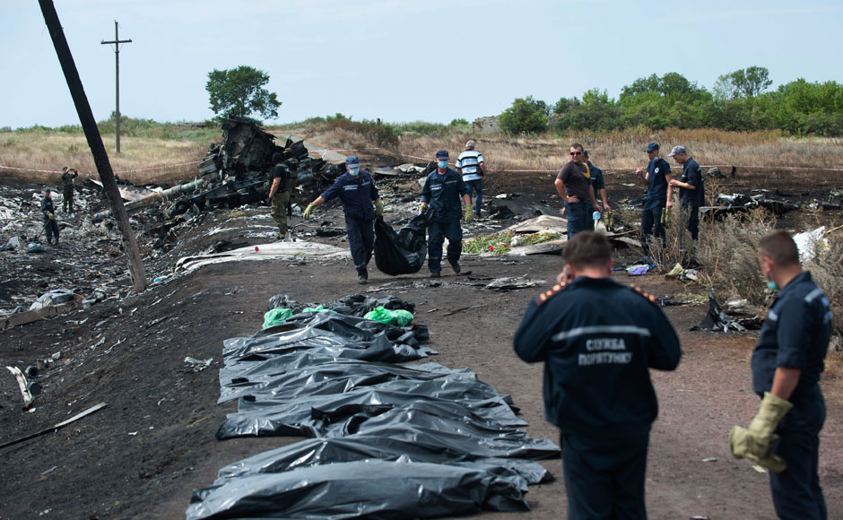 Ukrainian Emergency workers carry a victim's body in a bag as pro-Russian fighters stand in guard at the crash site of Malaysia Airlines Flight 17 near the village of Hrabove, eastern Ukraine, Sunday, July 20, 2014. Rebels in eastern Ukraine took control Sunday of the bodies recovered from downed Malaysia Airlines Flight 17, and the U.S. and European leaders demanded that Russian President Vladimir Putin make sure rebels give international investigators full access to the crash site.
![Firstpost